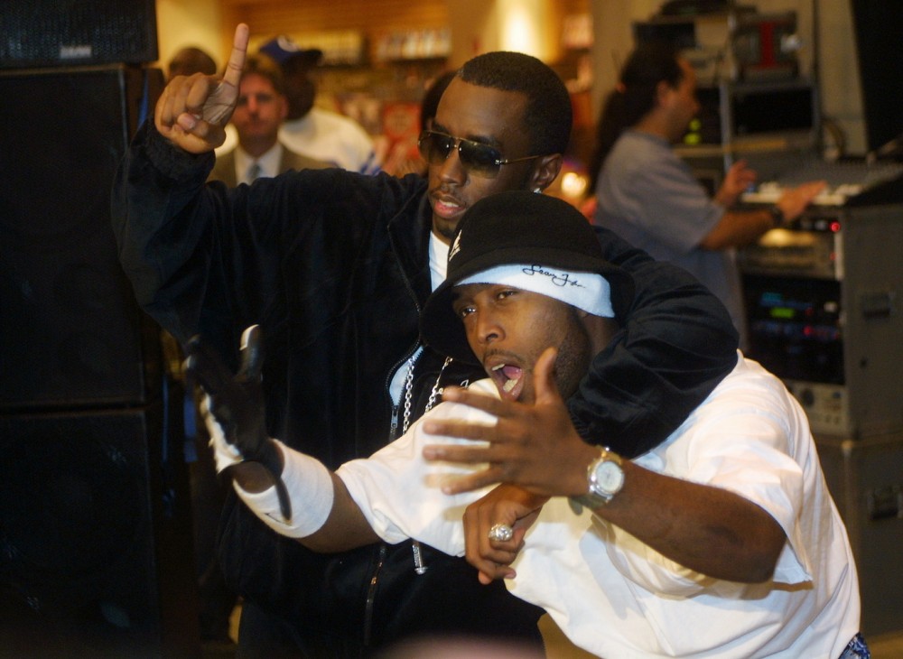 Diddy and Black Rob pose at Virgin Mega Store in Times Square for the midnight release of 'The Saga Continues'